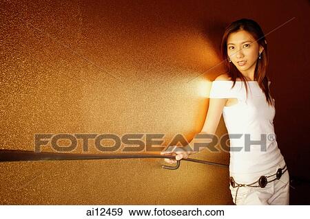 Young woman holding handrail, looking at camera View Large Photo Image Stock Photo - Young woman holding handrail, looking at camera. Fotosearch
