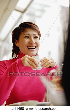 Young woman holding teacup, looking away View Large Photo Image Stock Photo - Young woman holding teacup, looking away. Fotosearch