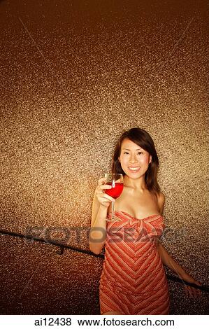 Young woman, holding wine glass, looking at camera View Large Photo Image Stock Photo - Young woman, holding wine glass, looking at camera. Fotosearch