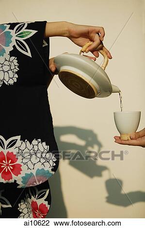 Young woman in kimono pouring tea for someone. View Large Photo Image Stock Image - Young woman in kimono pouring tea for someone.. Fotosearch