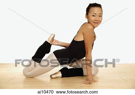 Young woman in leotard holding her leg and stretching View Large Photo Image Stock Image - Young woman in leotard holding her leg and stretching. Fotosearch
