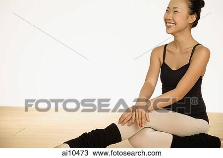 Young woman in leotard sitting upright, smiling View Large Photo Image Stock Image - Young woman in leotard sitting upright, smiling. Fotosearch