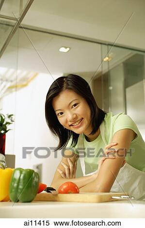 Young woman leaning on kitchen counter, arms crossed View Large Photo Image Stock Photography - Young woman leaning on kitchen counter, arms crossed. Fotosearch