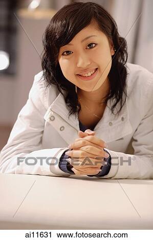 Young woman, looking at camera, hands clasped View Large Photo Image Stock Image - Young woman, looking at camera, hands clasped. Fotosearch