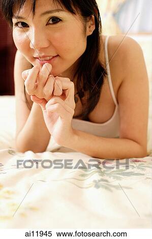Young woman looking at camera, hands clasped View Large Photo Image Stock Photography - Young woman looking at camera, hands clasped. Fotosearch