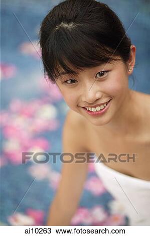 Young woman looking at camera, pool in the background View Large Photo Image Stock Image - Young woman looking at camera, pool in the background. Fotosearch