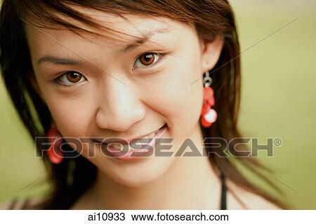 Stock Image - Young woman, looking at camera, portrait. Fotosearch