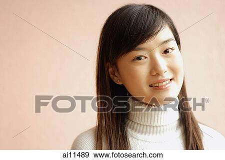 Young woman looking at camera, portrait View Large Photo Image Stock Photo - Young woman looking at camera, portrait. Fotosearch