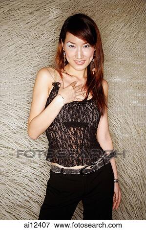 Stock Photo - Young woman looking at camera, portrait. Fotosearch