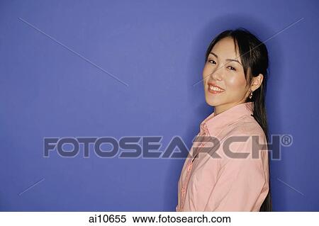 Young woman, looking at camera, smiling View Large Photo Image Stock Photography - Young woman, looking at camera, smiling. Fotosearch