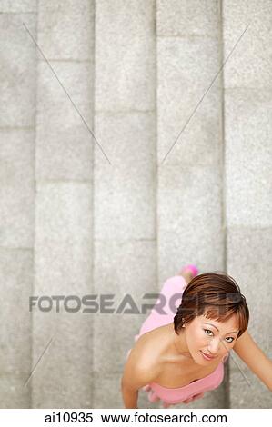 Young woman, looking at camera, directly above View Large Photo Image Stock Photography - Young woman, looking at camera, directly above. Fotosearch