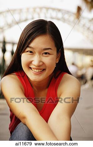 Young woman looking at camera, toothy smile View Large Photo Image Stock Photo - Young woman looking at camera, toothy smile. Fotosearch