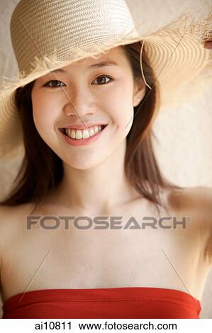 Young woman looking at camera, wearing hat View Large Photo Image Stock Image - Young woman looking at camera, wearing hat. Fotosearch