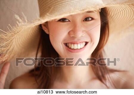 Young woman looking at camera, wearing hat View Large Photo Image Stock Image - Young woman looking at camera, wearing hat. Fotosearch