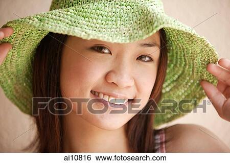 Young woman looking at camera, wearing hat View Large Photo Image Stock Photograph - Young woman looking at camera, wearing hat. Fotosearch