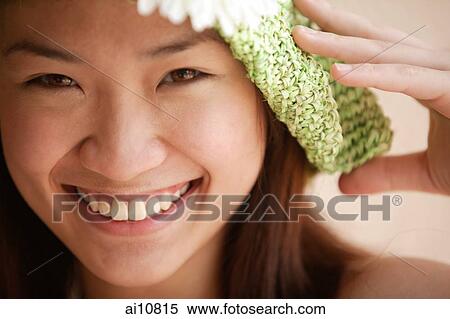 Young woman looking at camera, wearing hat View Large Photo Image Stock Photography - Young woman looking at camera, wearing hat. Fotosearch