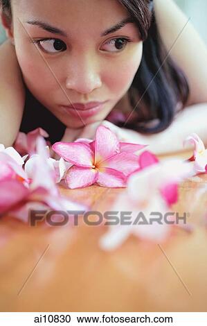 Young woman, looking away, flowers in front on her View Large Photo Image Stock Image - Young woman, looking away, flowers in front on her. Fotosearch