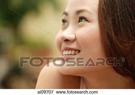 Young woman looking away, smiling View Large Photo Image Stock Photo - Young woman looking away, smiling. Fotosearch