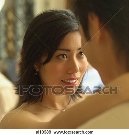 Young woman looking up at young man View Large Photo Image Stock Photo - Young woman looking up at young man. Fotosearch