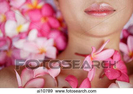 Young woman lying down amidst flowers, eyes closed View Large Photo Image Stock Photo - Young woman lying down amidst flowers, eyes closed. Fotosearch