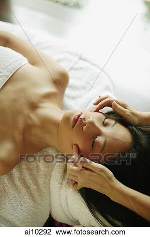 Young woman lying down on massage table being massaged View Large Photo Image Stock Image - Young woman lying down on massage table being massaged. Fotosearch