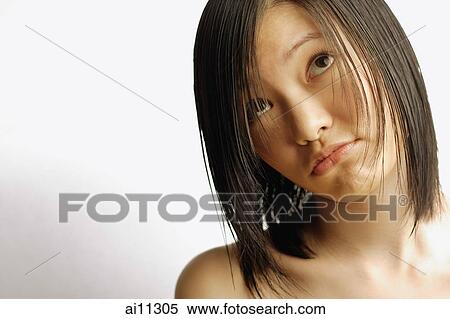 Young woman making a face, looking up View Large Photo Image Stock Photography - Young woman making a face, looking up. Fotosearch