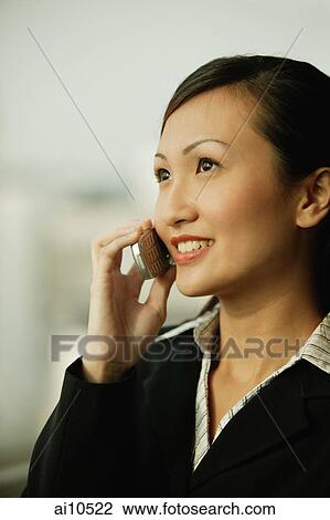Young woman on mobile phone, smiling View Large Photo Image Stock Image - Young woman on mobile phone, smiling. Fotosearch