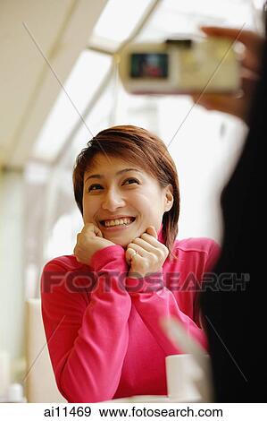 Young woman posing while another person takes her picture View Large Photo Image Stock Photo - Young woman posing while another person takes her picture. Fotosearch