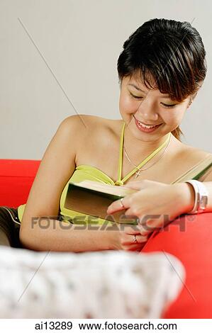 Young woman reading a book, portrait View Large Photo Image Stock Photo - Young woman reading a book, portrait. Fotosearch