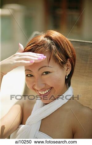 Young woman shielding eyes, looking at camera View Large Photo Image Stock Image - Young woman shielding eyes, looking at camera. Fotosearch