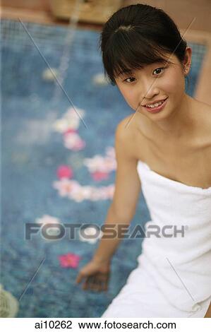 Young woman sitting by pool View Large Photo Image Stock Image - Young woman sitting by pool. Fotosearch