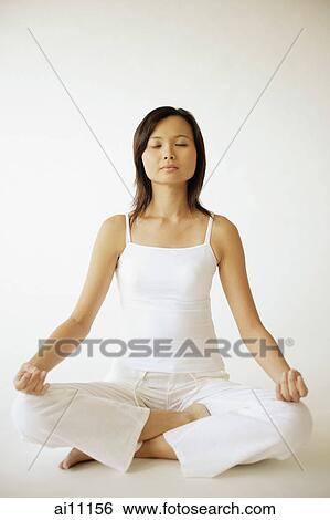 Young woman sitting in lotus position View Large Photo Image Stock Photograph - Young woman sitting in lotus position. Fotosearch