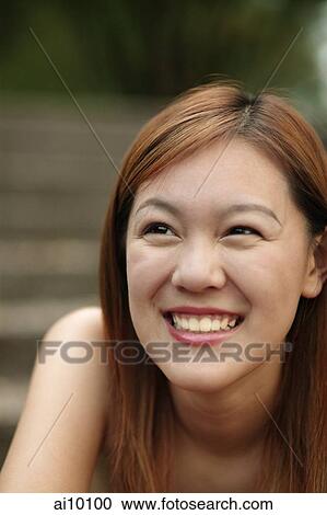 Young woman smiling, looking away View Large Photo Image Stock Image - Young woman smiling, looking away. Fotosearch