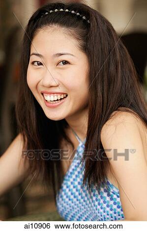 Young woman smiling, portrait View Large Photo Image Stock Photograph - Young woman smiling, portrait. Fotosearch