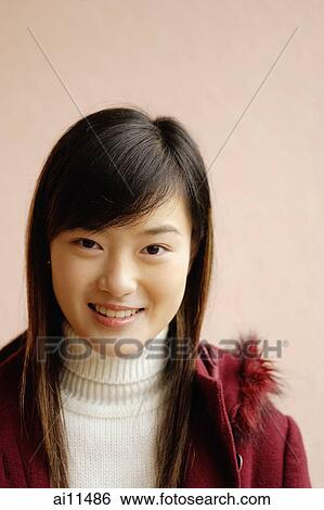 Stock Photograph - Young woman smiling, portrait. Fotosearch