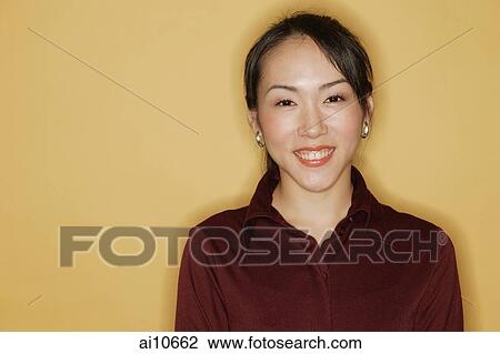 Young woman, smiling, yellow background View Large Photo Image Stock Image - Young woman, smiling, yellow background. Fotosearch