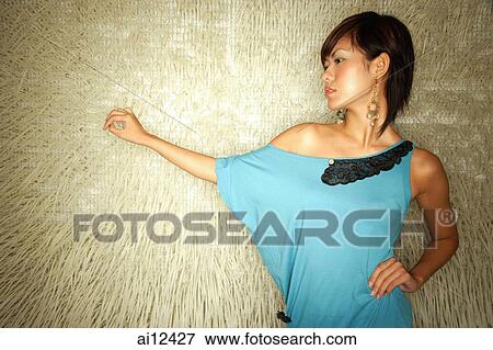 Young woman standing, hand on hip View Large Photo Image Stock Photo - Young woman standing, hand on hip. Fotosearch