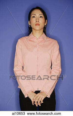 Young woman, standing, hands clasped View Large Photo Image Stock Image - Young woman, standing, hands clasped. Fotosearch