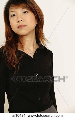 Young woman standing, looking at camera View Large Photo Image Stock Image - Young woman standing, looking at camera. Fotosearch