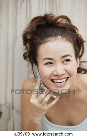 Young woman using cellular phone View Large Photo Image Stock Photo - Young woman using cellular phone. Fotosearch