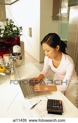 Young woman using laptop, high angle view View Large Photo Image Stock Photography - Young woman using laptop, high angle view. Fotosearch