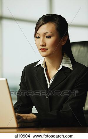 Young woman using laptop View Large Photo Image Picture - Young woman using laptop. Fotosearch