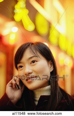 Young woman using mobile phone, neon signs behind her View Large Photo Image Stock Photo - Young woman using mobile phone, neon signs behind her. Fotosearch