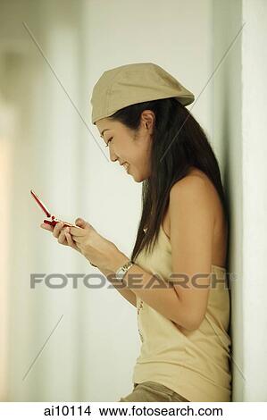 Young woman using mobile phone View Large Photo Image Picture - Young woman using mobile phone. Fotosearch