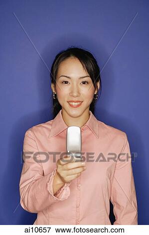 Young woman, using mobile phone, smiling View Large Photo Image Stock Photo - Young woman, using mobile phone, smiling. Fotosearch