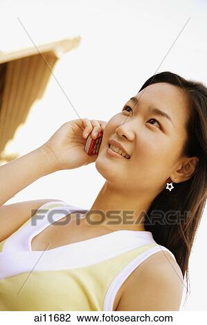Young woman using mobile phone View Large Photo Image Stock Image - Young woman using mobile phone. Fotosearch