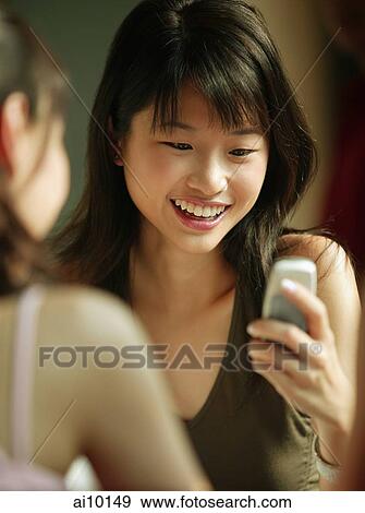 Young woman using mobile phone. View Large Photo Image Stock Photo - Young woman using mobile phone.. Fotosearch