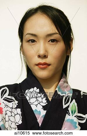 Stock Photography - Young woman wearing a kimono, looking at camera. Fotosearch