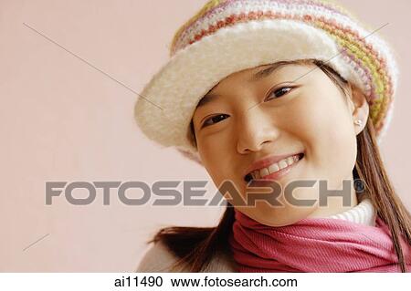 Young woman wearing cap, smiling View Large Photo Image Stock Image - Young woman wearing cap, smiling. Fotosearch