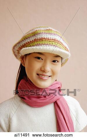 Young woman wearing cap, smiling, portrait View Large Photo Image Stock Image - Young woman wearing cap, smiling, portrait. Fotosearch